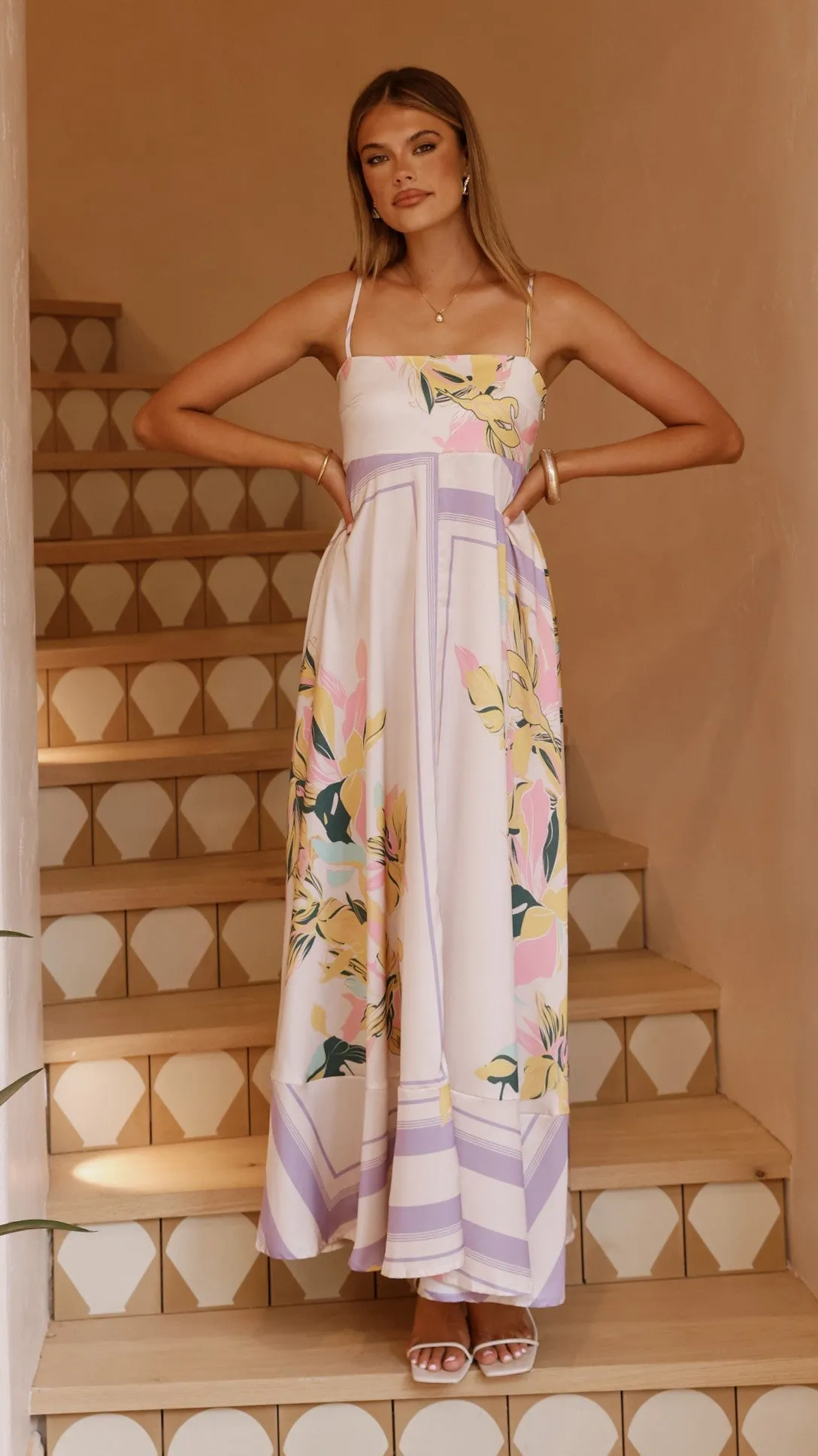 This dress offers a comfortable and elegant fit that works for both casual and formal events The flattering shape of this dress creates a beautiful silhouette that is perfect for all body types Kaethe Maxi Dress - Beige/Lilac